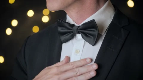 Close up view of man adjusts his bow tie. Stock Footage 203843233