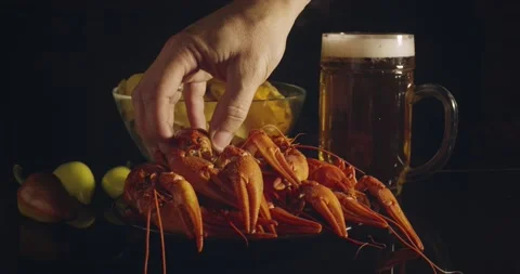 Close up view of man arm taking lobsters with bear and chips on background Stock Footage 142736251