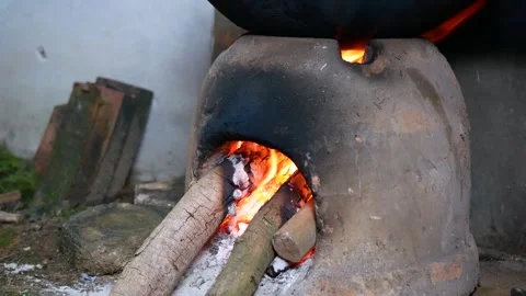 Close-up view of man arranging firewood in Earthenware furnace Stock Footage 281220440
