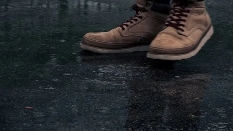 Close-up View of Man in Boots is Waiting in the Rain. 4K Ultra HD Stock Footage 81590167