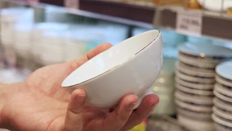 Close up view of a man choosing new porclain bowl for kitchen Stock Footage 324874168