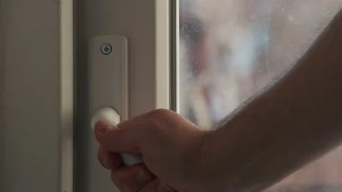 Close up view of man close balcony door by handle. Sunny day, balcony door Vidéo 233547541