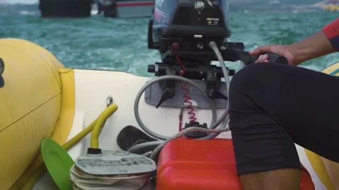 Close up view of a man controlling a motor inflatable boat in the sea. Stock Footage 136454607