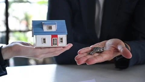 Close up view man customer receiving keys of new house from real estate agent Stock Photos