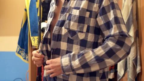 Close up view the man dresses the checkered shirt. Stock Photos