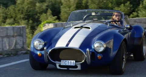 Close view of a man driving a blue luxury car in the middle of nature in Monaco Vídeos de archivo 150210971