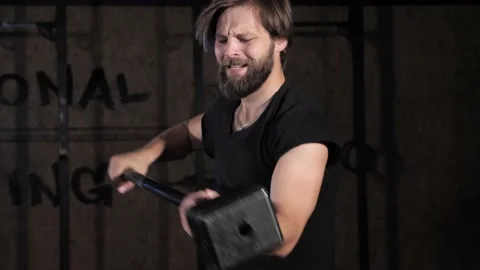 Close up view of man exercising with hammer during crossfit training at gym. Stock-Footage 142225781