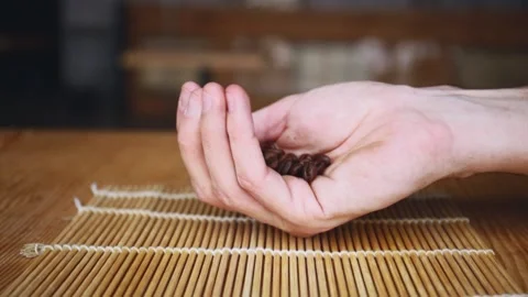 Close up view of man hand holding roasted coffee beans 库存影片 150402119