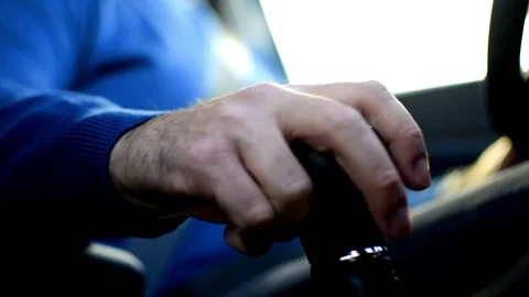Close-up view of a man hand that holds a gear while driving. 库存影片 120426146