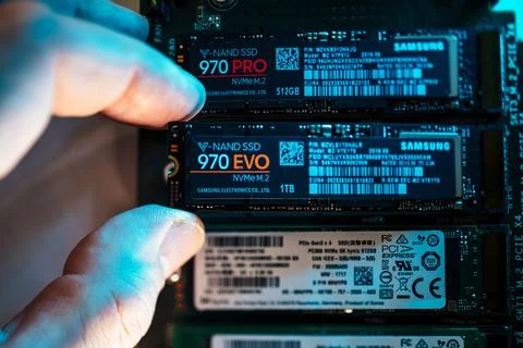 Close-up view of man hand inserting in the M2 connector the new Samsung NVME 스톡 사진