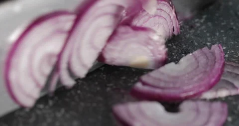 Close up view of a man hands cut red onion into slices with a knife Stock-Footage 144629812