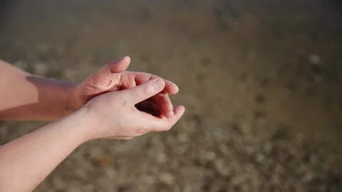 Close up view of man hands on the sea water background. On the Dead Sea Stock Footage 181647044