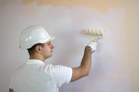 Close up view of man holding paint roller Stock Photos