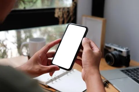 Close up view man holding smart phone with empty display.. Stock Photos