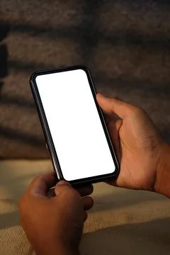 Close up view man holding smart phone with white empty display. Stock Photos