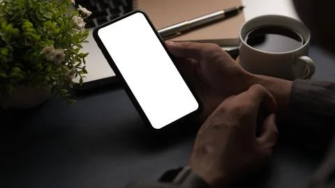 Close up view man holding smart phone with empty display. Stock Photos