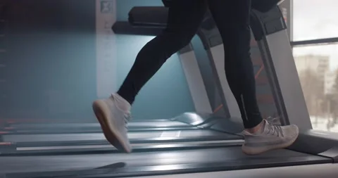 Close up view of man legs in sneakers running on treadmill at gym, slow motion Video stock 149483360