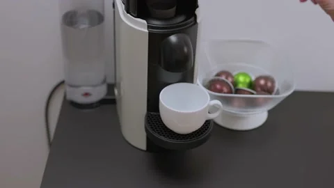 Close up view of a man loading coffee capsules into a coffee machine. Sweden. Stock Footage 170599731