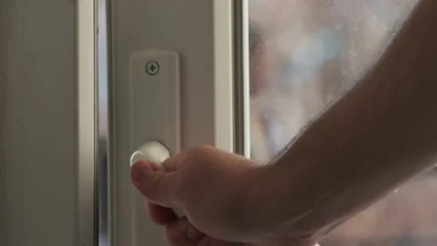 Close up view of man open balcony door by handle. Sunny day, balcony door opens. Vidéo 232348171