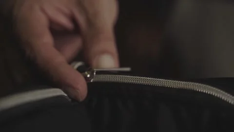 Close view of a man opening the zip of a bag Stock Footage 133005162