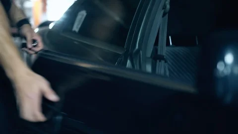 Close view man opens black car door gets in on parking lot Stock-Footage 104324043