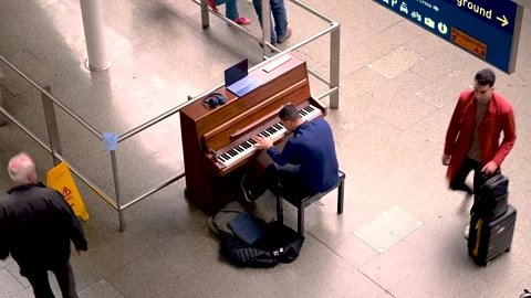 Close View of Man Playing Public Piano at Rail Terminal Stock Footage 337583671