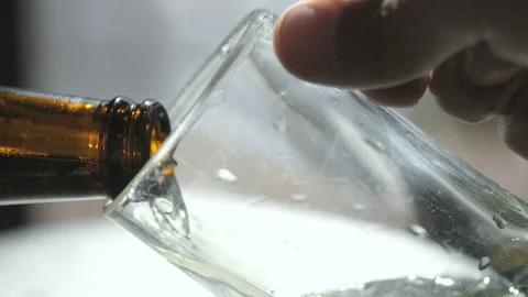 Close up view of man puoring beer from bottle into a glass mug,alcohol addiction Stock Footage 140741449