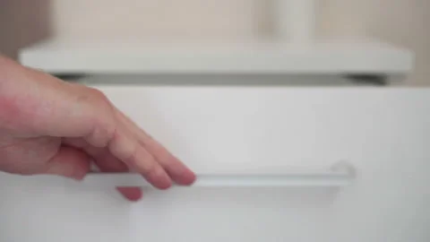 Close-up view of man put a notebook into a drawer Stock Footage 155979970