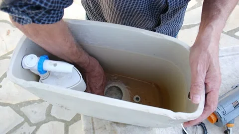 Close up view of man repair dirty rusty toilet tank outdoor Stock Footage 238400147