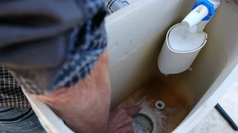 Close up view of man repair dirty rusty toilet tank outdoor Stock Footage 238400148