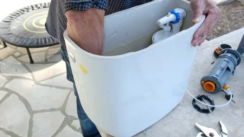 Close up view of man repair dirty rusty toilet tank outdoor Stock Footage 238400183