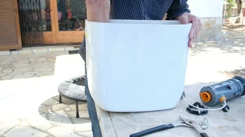 Close up view of man repair dirty rusty toilet tank outdoor Stock Footage 238400217