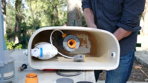 Close up view of man repair dirty rusty toilet tank outdoor Stock Footage 238400342