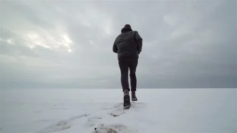 Close-up view of Man running in winter snowy landscape in Slow Motion Stock Footage 199485352