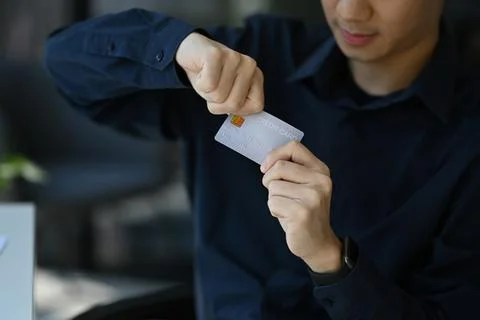 Close up view of man solving his problems by destroying his credit card Stockfoto's