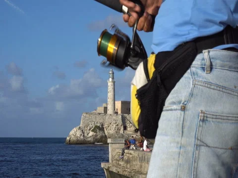 Close-up view of a man spinning reel the bait on pier Video stock 70990343