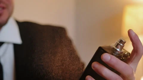 Close up view of man splits the perfume on himself. Slow motion Stock-Footage 273724090