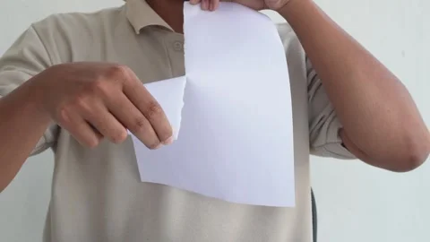 Close-up view of a man tearing paper with his hands Stock Footage 338441155