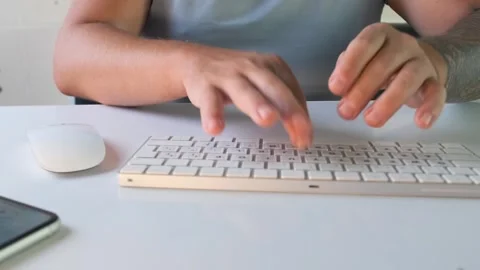 Close view of man typing on compact wireless keyboard with mouse and smartphone 스톡 동영상 333768893