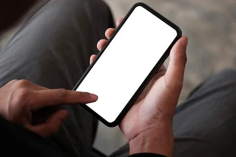 Close up view man using mobile phone in living room... Stock Photos