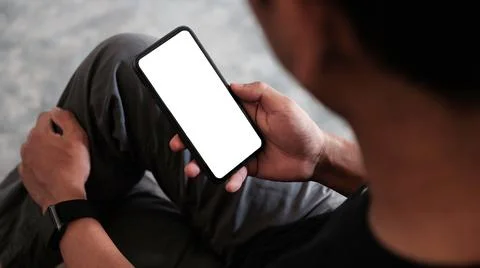Close up view man using mobile phone in living room... Stock Photos