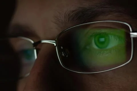 Close up view of man wears computer glasses for reducing eye strain blurred v Foto stock