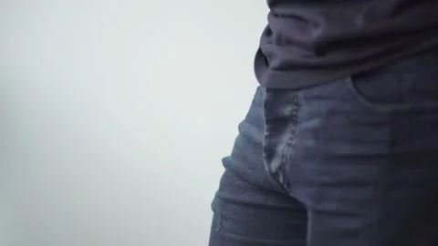 Close-up view of man wipes his hands on jeans Stock Footage 128553474