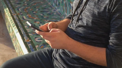 Close up view of a man working and using his mobile phone outdoors -  working wi Stock Footage 121449788