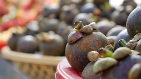 A close-up view of mangosteens showcases their rustic charm, with textured peels Stock Footage 307378422