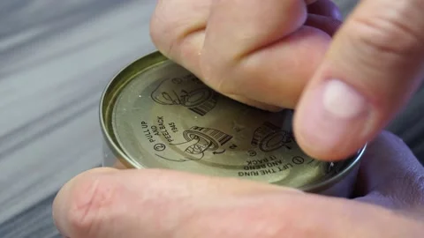 A close-up view of a man's finger opens a tin aluminum can with a delicacy -  Stock Footage 170877222