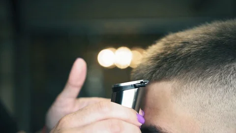 Close up view on man's hair cutted with electric clipper in barbershop. Haircut Stock Footage 93753986