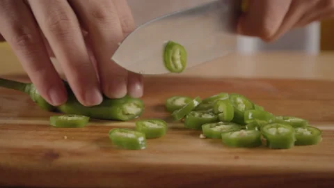 Close view man's hand chopping green fresh pepper with sharp knife. Stock Footage 171595781