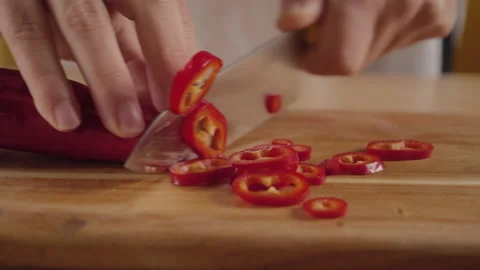 Close view man's hand chopping red fresh pepper with sharp knife. Stock Footage 171636760