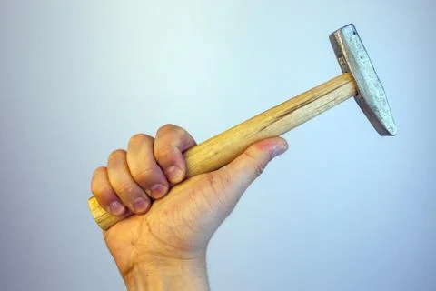Close-up view of a man's hand holding hammer, isolated on white background. R Foto stock